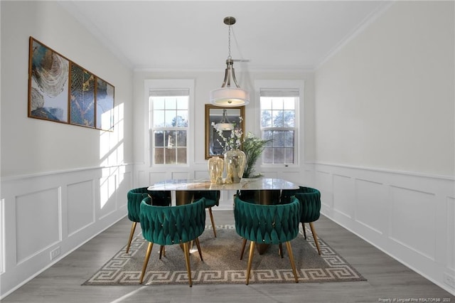 dining area with a wealth of natural light, crown molding, and dark hardwood / wood-style floors