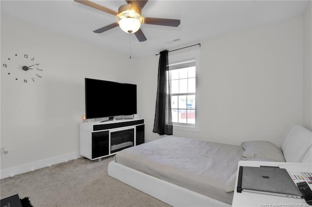 bedroom with light colored carpet and ceiling fan