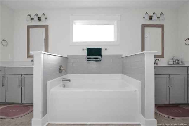 bathroom featuring vanity, a bathtub, and tile patterned floors