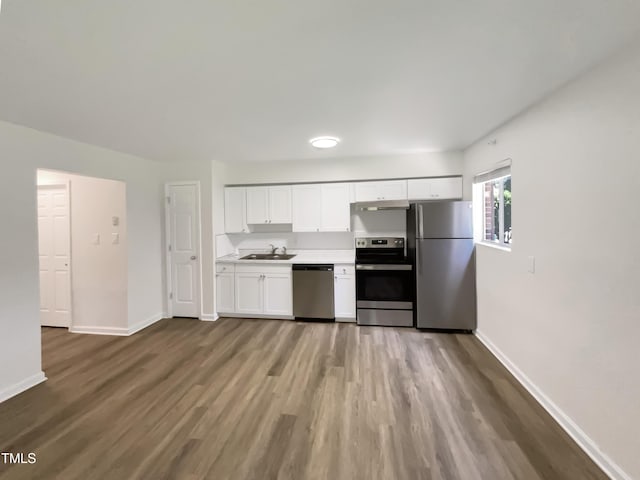 130 S Estes Dr Unit B7, Chapel Hill, NC 27514 - kitchen with appliances with stainless steel finishes, white cabinets, wood finished floors, and light countertops
