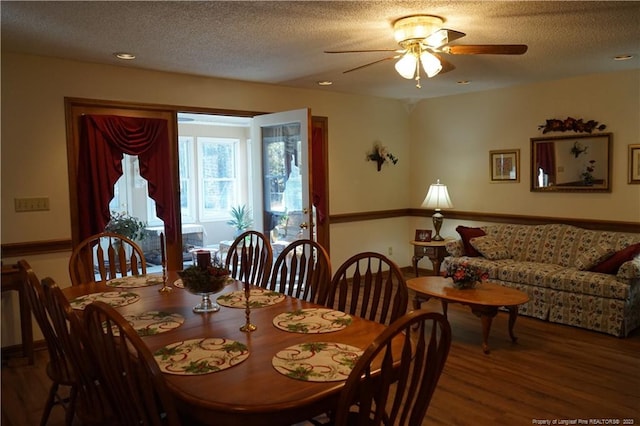 dining space featuring ceiling fan, hardwood / wood-style floors, and a textured ceiling