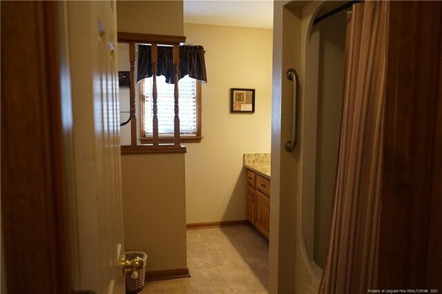 bathroom with vanity and a shower