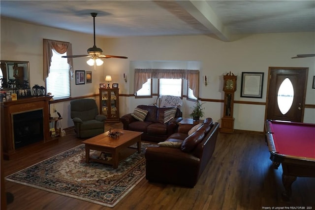 living room with dark wood-type flooring, ceiling fan, and beam ceiling