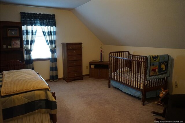 carpeted bedroom featuring lofted ceiling