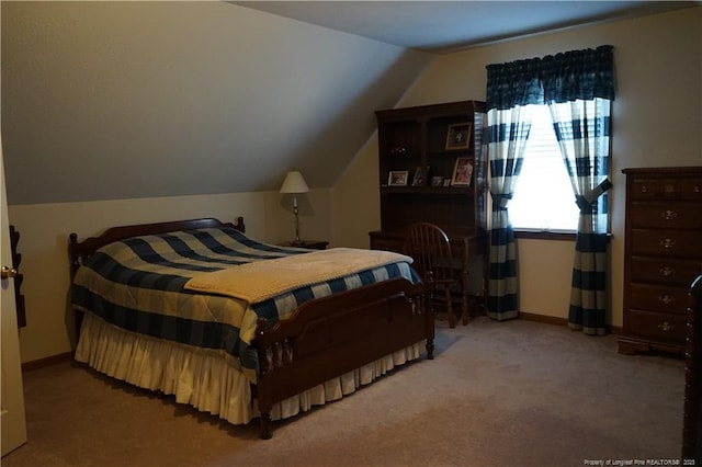 carpeted bedroom with lofted ceiling