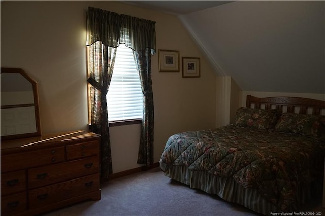 bedroom featuring multiple windows, light carpet, and vaulted ceiling