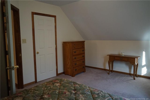 carpeted bedroom with lofted ceiling