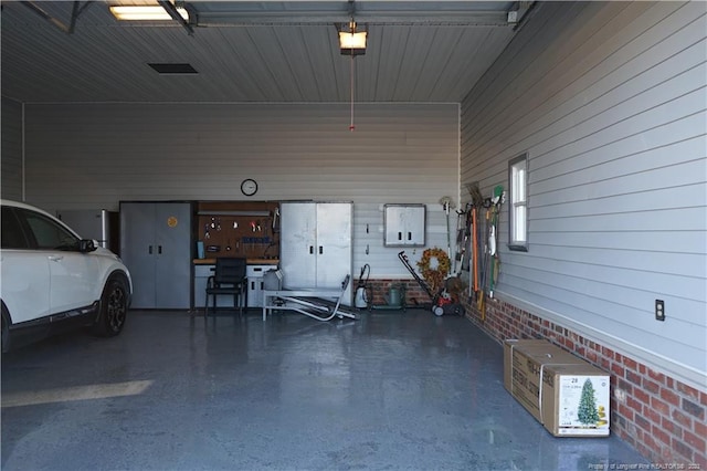 garage with a carport and a garage door opener