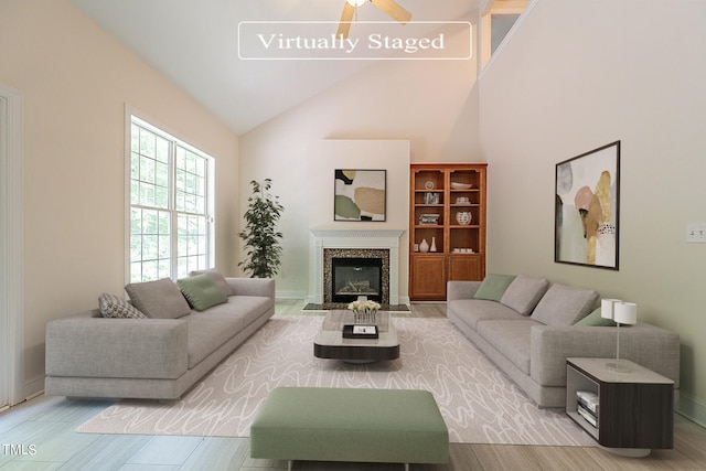 living room with ceiling fan and high vaulted ceiling