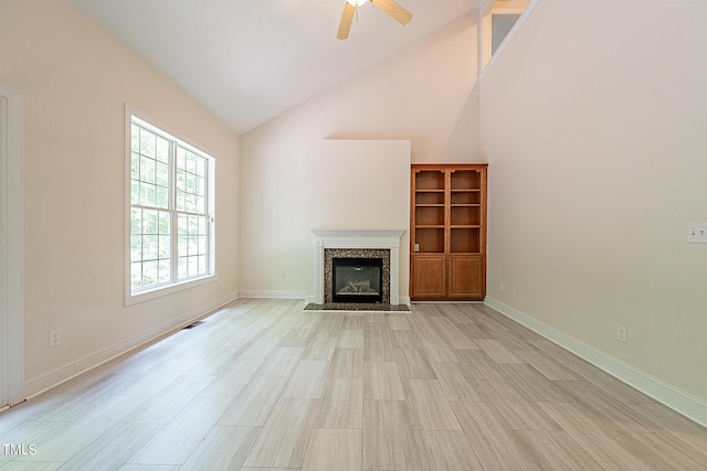 unfurnished living room with high vaulted ceiling, a fireplace, visible vents, a ceiling fan, and baseboards