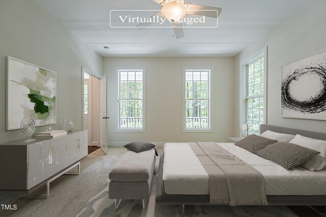 bedroom with ceiling fan, multiple windows, and carpet