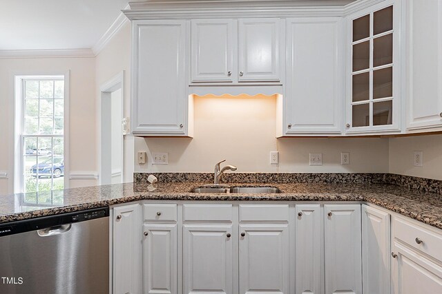 kitchen featuring dark stone countertops, crown molding, sink, white cabinetry, and stainless steel dishwasher