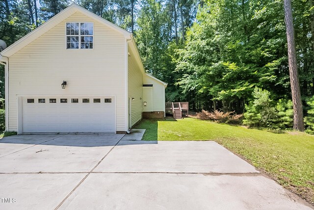 view of property exterior with a lawn and a garage