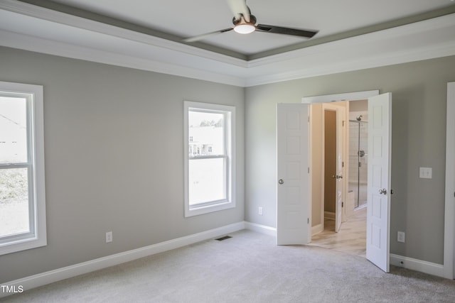 unfurnished bedroom featuring light colored carpet, ceiling fan, and ornamental molding