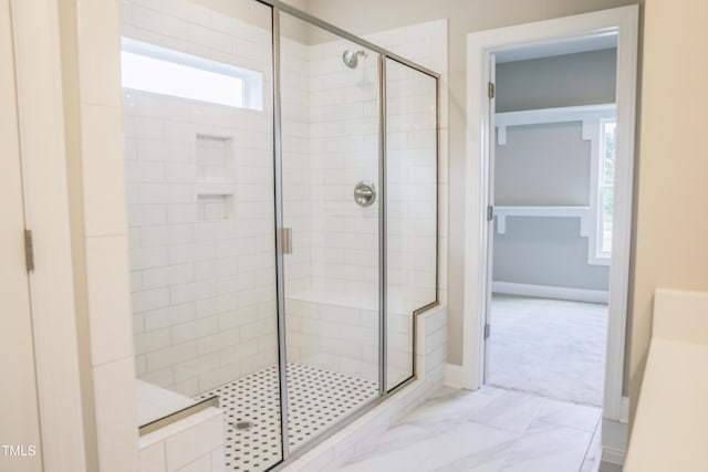 bathroom featuring a shower with shower door