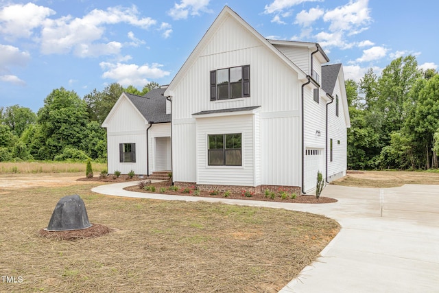 7327 Shawan Rd, Wendell, NC 27591 - modern farmhouse style home featuring driveway, an attached garage, roof with shingles, and board and batten siding
