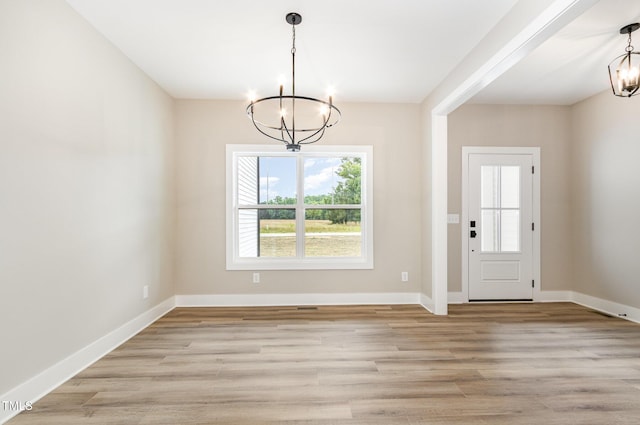 7327 Shawan Rd, Wendell, NC 27591 - foyer entrance with a chandelier, light wood-style floors, and baseboards