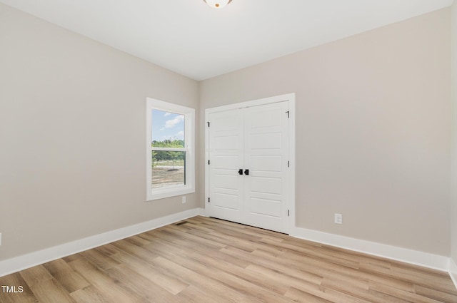 7327 Shawan Rd, Wendell, NC 27591 - unfurnished bedroom with light wood-type flooring, baseboards, and a closet