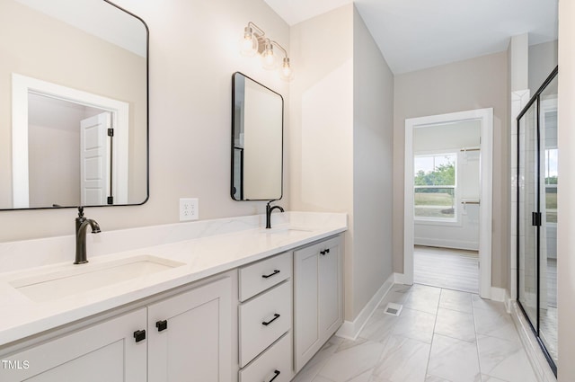 7327 Shawan Rd, Wendell, NC 27591 - bathroom featuring double vanity, a stall shower, marble look tiles, and baseboards