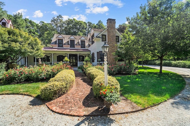 cape cod home with a front yard