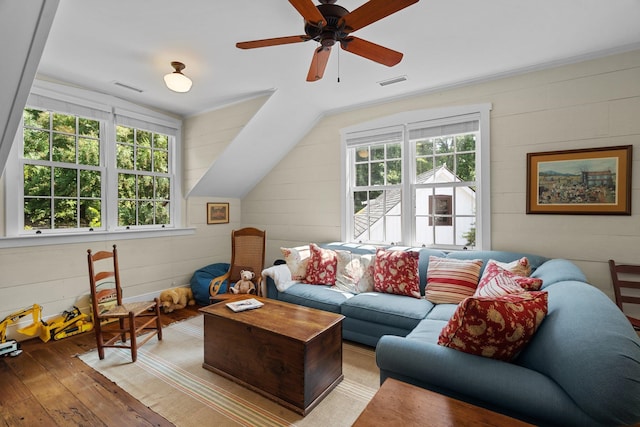 living room with ceiling fan, light hardwood / wood-style flooring, and vaulted ceiling