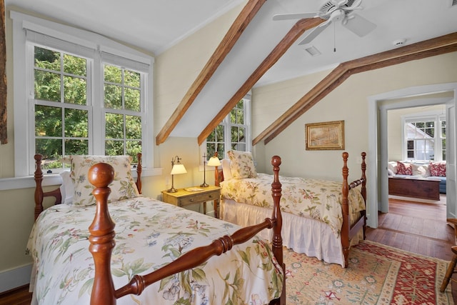 bedroom featuring wood-type flooring, lofted ceiling with beams, and ceiling fan