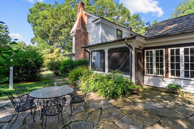 view of patio featuring a sunroom