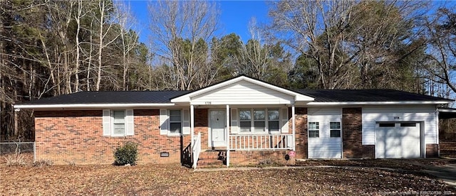 single story home featuring a porch and a garage