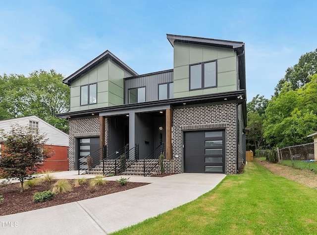 modern home with a garage and a front lawn