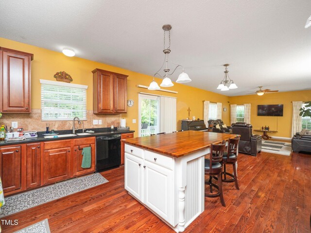 1209 Partington St, Wake Forest, NC 27587 - kitchen featuring black dishwasher, a sink, open floor plan, dark wood finished floors, and wooden counters