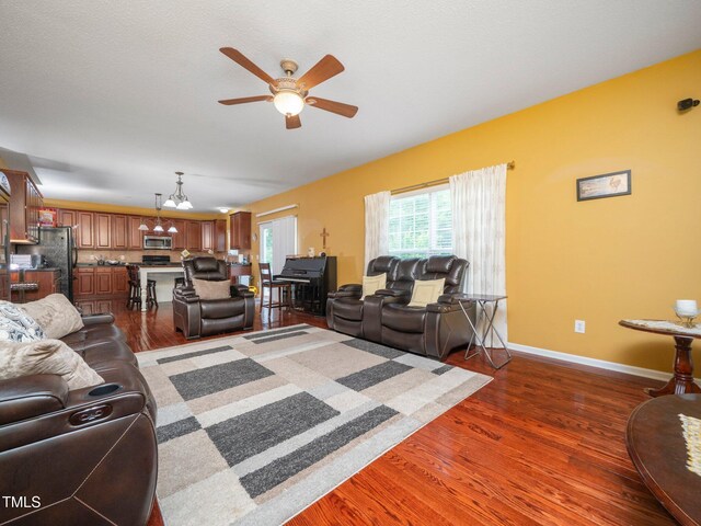 1209 Partington St, Wake Forest, NC 27587 - living area featuring ceiling fan, dark wood-style flooring, a chandelier, and baseboards