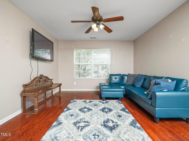 1209 Partington St, Wake Forest, NC 27587 - living room with ceiling fan, wood finished floors, baseboards, and a textured ceiling