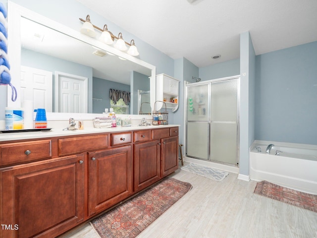 1209 Partington St, Wake Forest, NC 27587 - bathroom with a shower stall, double vanity, wood finished floors, and a garden tub