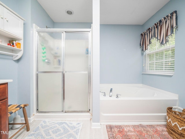 1209 Partington St, Wake Forest, NC 27587 - bathroom with a shower stall, a garden tub, baseboards, and vanity