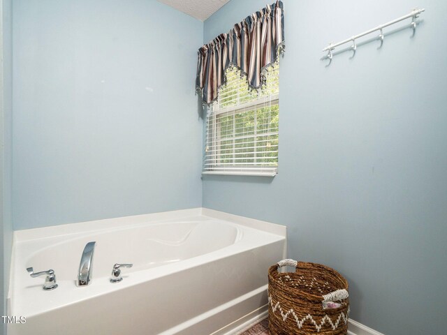 1209 Partington St, Wake Forest, NC 27587 - full bath featuring a bath and a textured ceiling