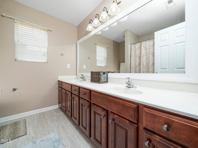 1209 Partington St, Wake Forest, NC 27587 - full bath featuring double vanity, healthy amount of natural light, and baseboards