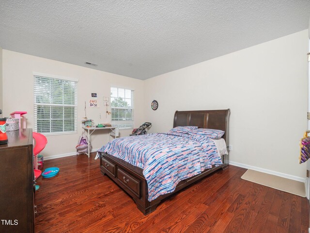 1209 Partington St, Wake Forest, NC 27587 - bedroom featuring wood finished floors, baseboards, and a textured ceiling