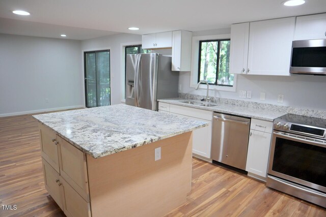 3404 Gemini Dr, Raleigh, NC 27604 - kitchen featuring recessed lighting, stainless steel appliances, a sink, light wood-type flooring, and a center island