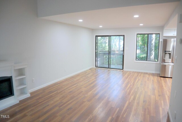 3404 Gemini Dr, Raleigh, NC 27604 - unfurnished living room with baseboards, wood finished floors, and recessed lighting