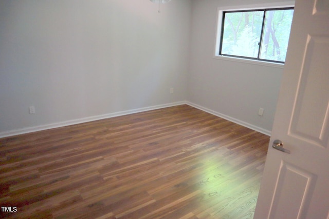 spare room with dark hardwood / wood-style floors and ceiling fan