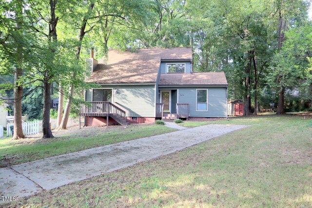 3404 Gemini Dr, Raleigh, NC 27604 - view of front facade featuring a chimney, an outdoor structure, a shed, and a front lawn