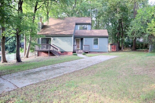 view of front of property featuring a storage unit and a front lawn