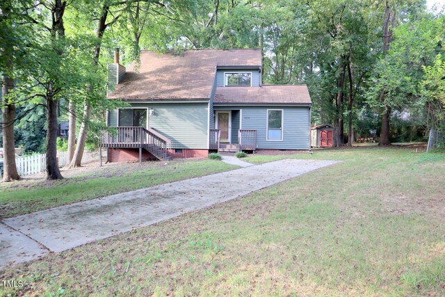 3404 Gemini Dr, Raleigh, NC 27604 - view of front facade with a chimney, fence, a shed, an outbuilding, and a front yard