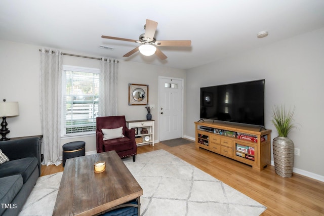 living room featuring hardwood / wood-style flooring and ceiling fan