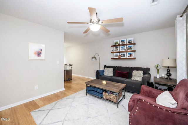 living room with hardwood / wood-style flooring and ceiling fan