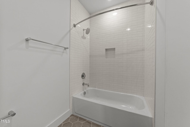 bathroom featuring tile patterned floors and tiled shower / bath