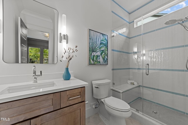 bathroom featuring vanity, tile patterned flooring, toilet, and an enclosed shower