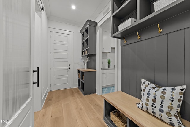 mudroom featuring crown molding and light hardwood / wood-style floors