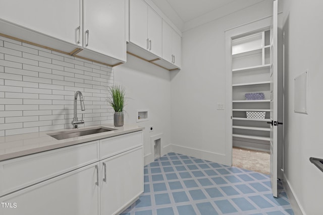 clothes washing area featuring cabinets, sink, electric dryer hookup, crown molding, and hookup for a washing machine