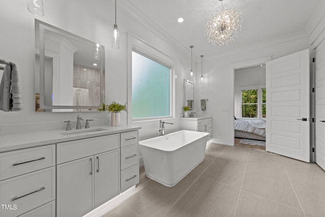 bathroom featuring crown molding, a bathing tub, vanity, and tile patterned floors